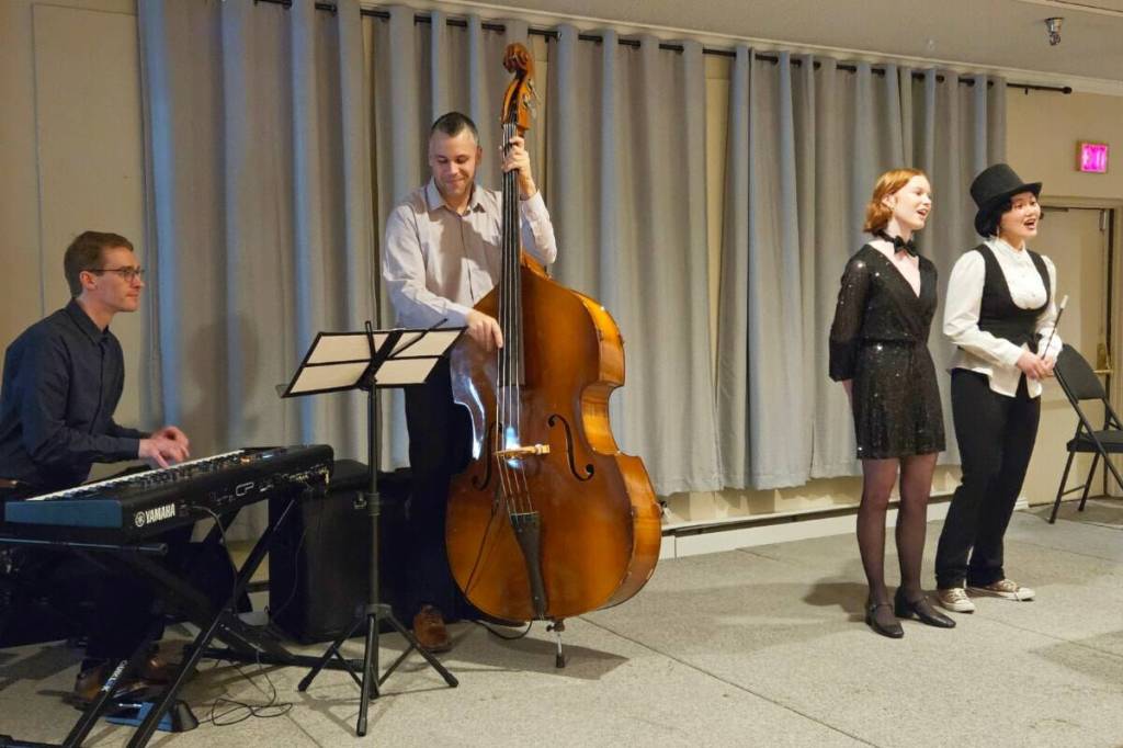 Daniel Sim, left, and Nick Sheasgreen accompany Interact Club members Lily Nguyen and Sam Martin in some songs with the theme of magic during one of the Rotary Club of Prince Rupert&rsquo;s previous Annual Foundation Dinners. (Thom Barker/Black Press Media)